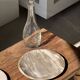Tray, circular dish or plate made of white striped grey petrified wood.
