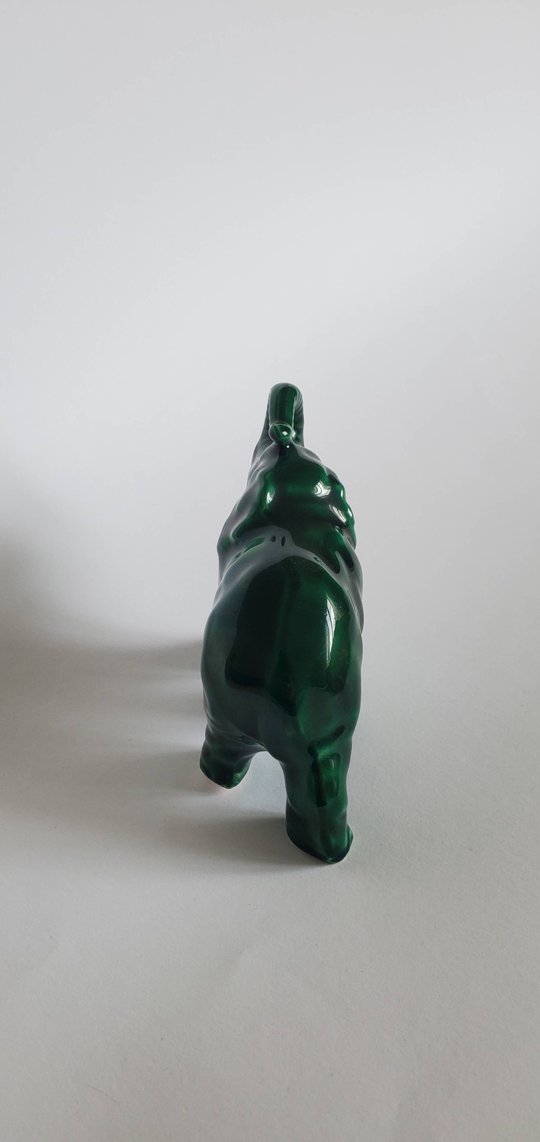 Small emerald green ceramic elephant.