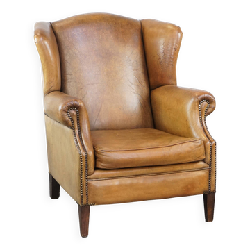 Fauteuil à oreilles en cuir de mouton patiné
