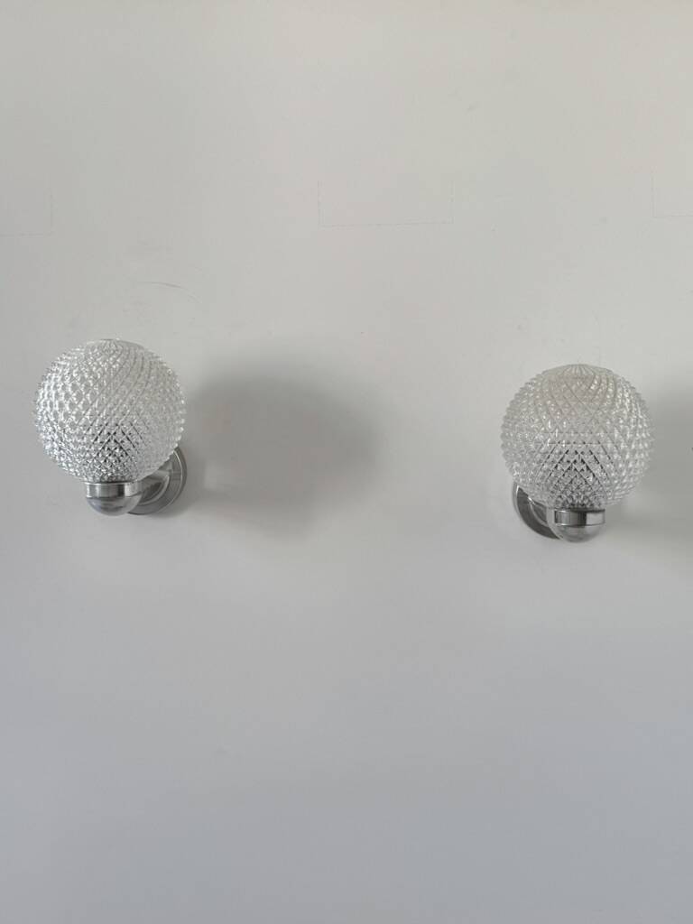 Pair of vintage wall lights in chrome metal and pressed moulded glass, France, 70s.