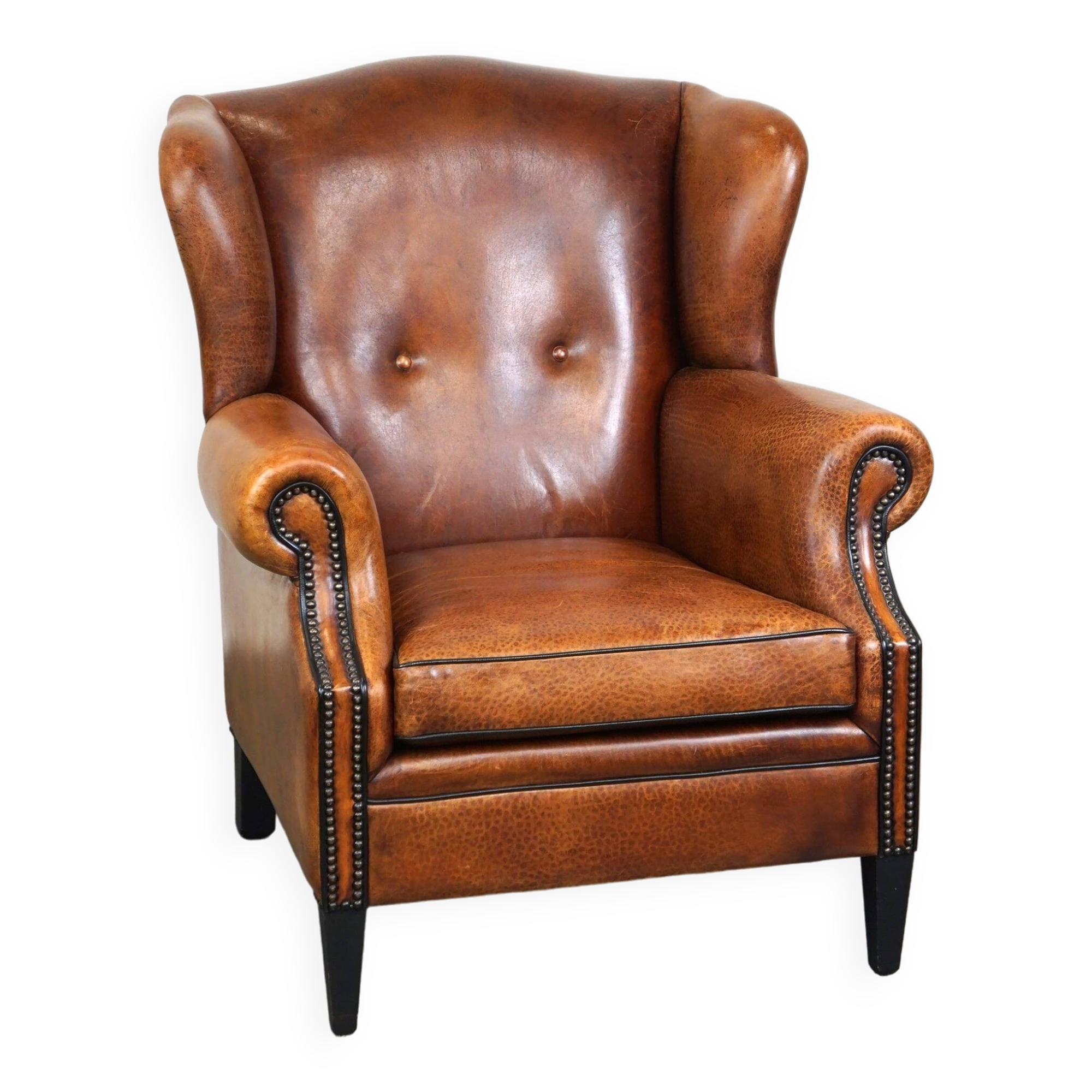 Sheepskin leather wingback armchair, with nails and black piping