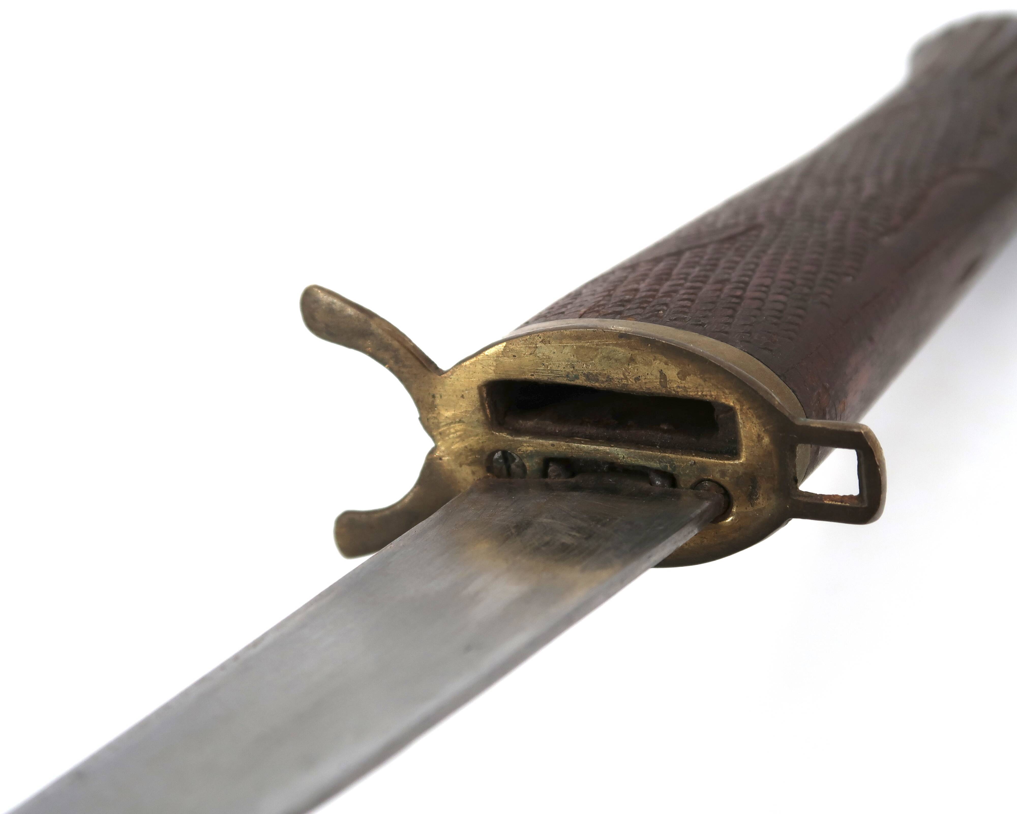 Fish knife and fork with a wooden and brass sheath sculpture.