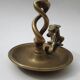 Antique bronze candlestick with dragon-shaped handle from the 17th century