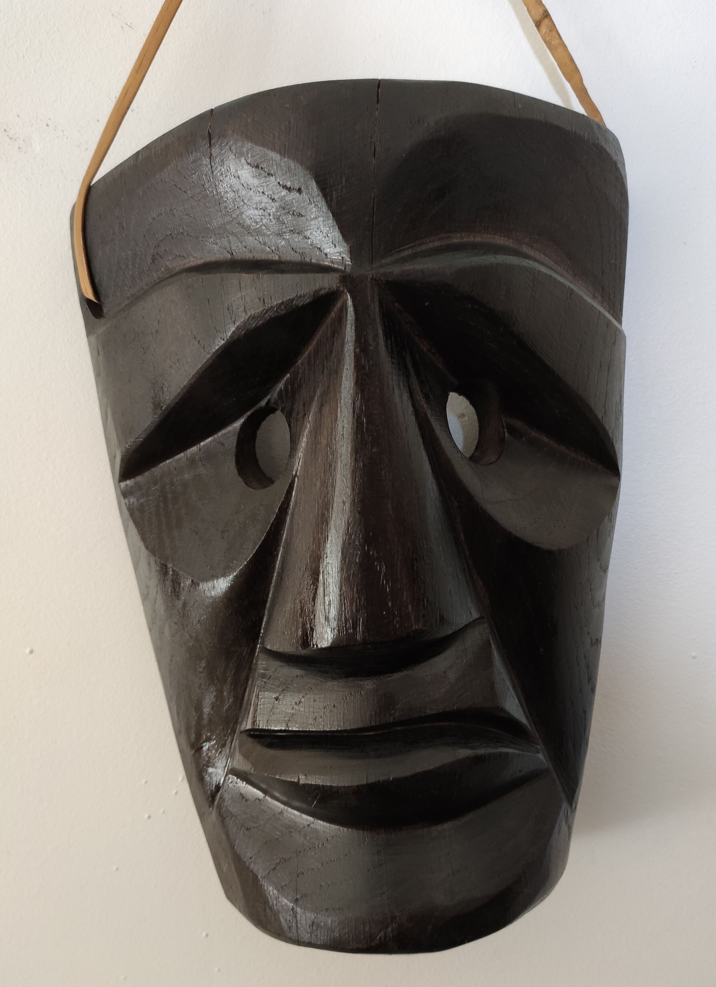 Ethnic ebony wood mask for display or hanging.