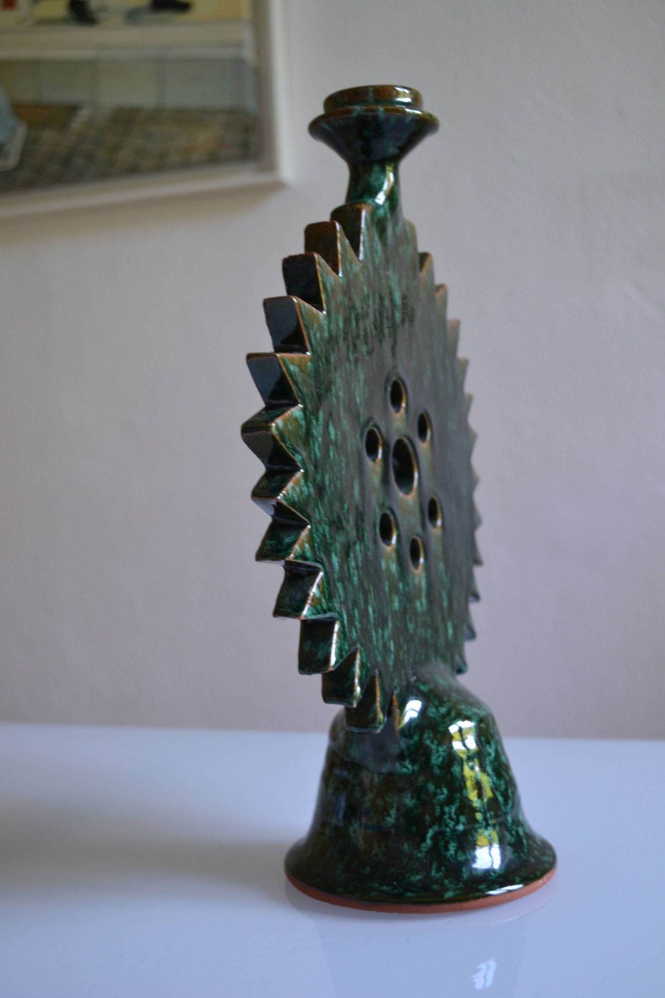 Green ceramic sun candlestick from Tamegroute, Morocco.