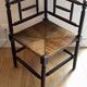 Corner chair made of turned wood with a straw seat.