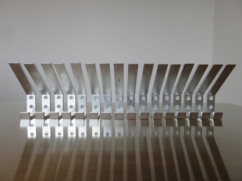 Series of 16 70s aluminium pads