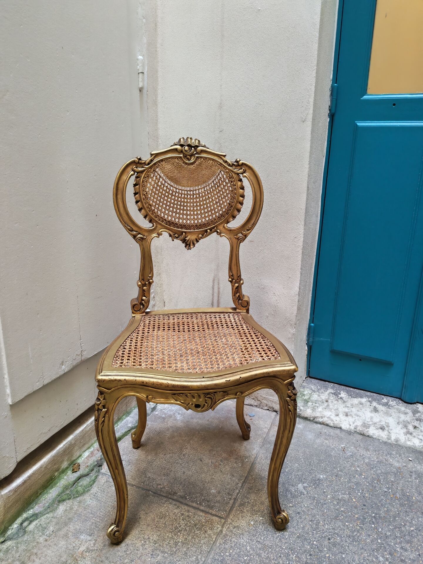 Antique rococo chair in gilded wood and caning