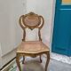 Antique rococo chair in gilded wood and caning