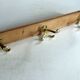 Wall mounted wooden coat rack with 3 brass hooks, vintage from the 50s