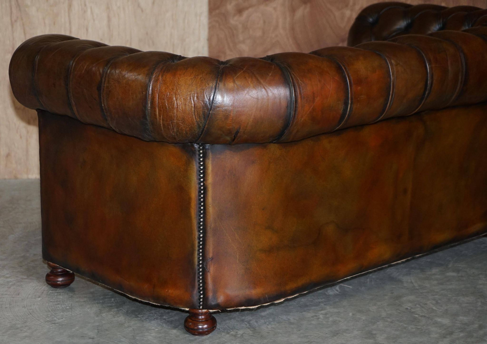 Restored leather Chesterfield sofa, walnut legs.