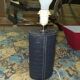 Ovoid lamp sheathed in braided blue leather and saddle stitching