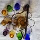Old Italian alcohol decanter and its colorful glasses