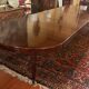 Extensible dining table from the Louis XVI period in mahogany with a banded top.