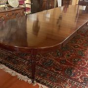 Extensible dining table from the Louis XVI period in mahogany with a banded top.