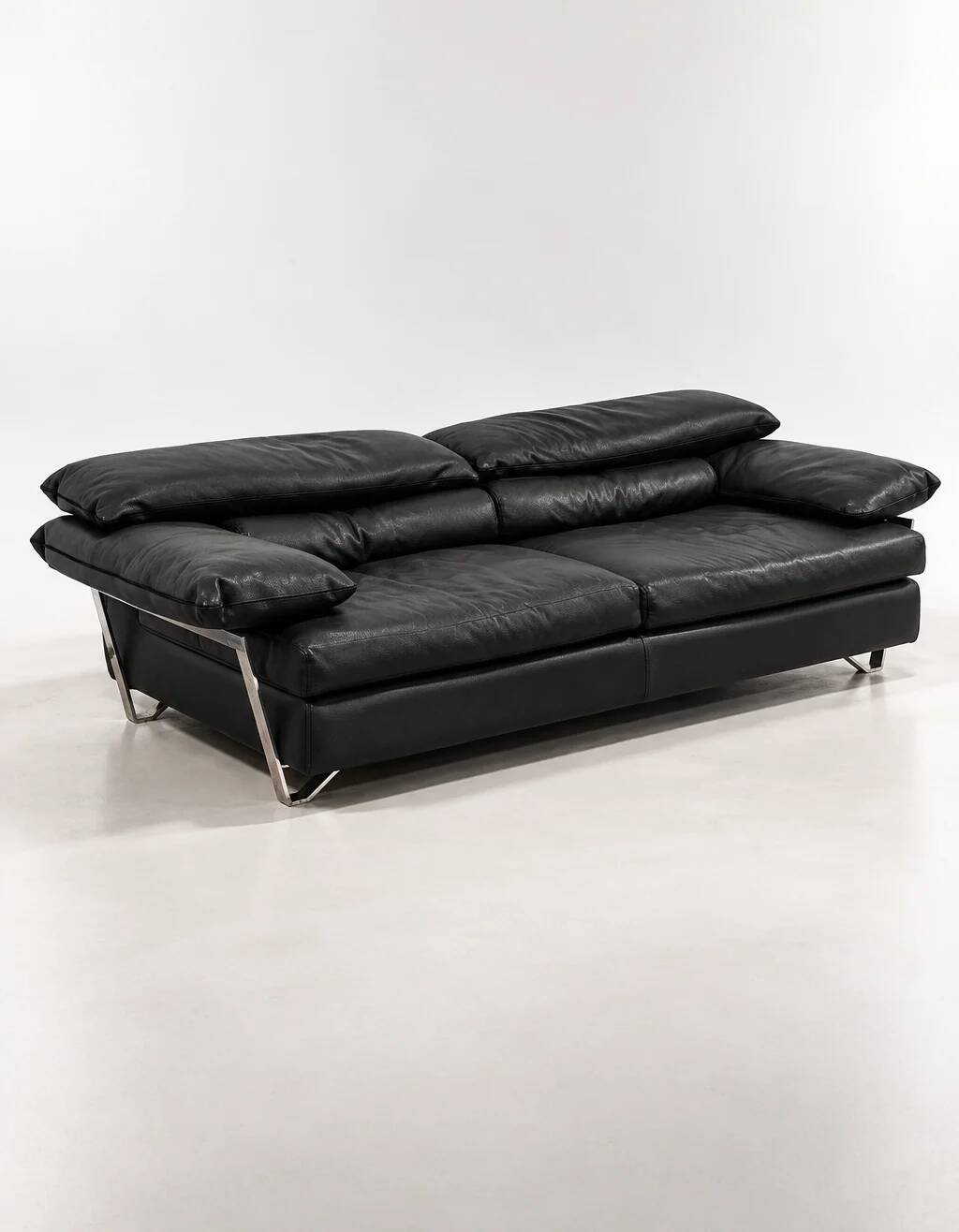 Two-seater black leather sofa from Roche Bobois with a chrome frame.
