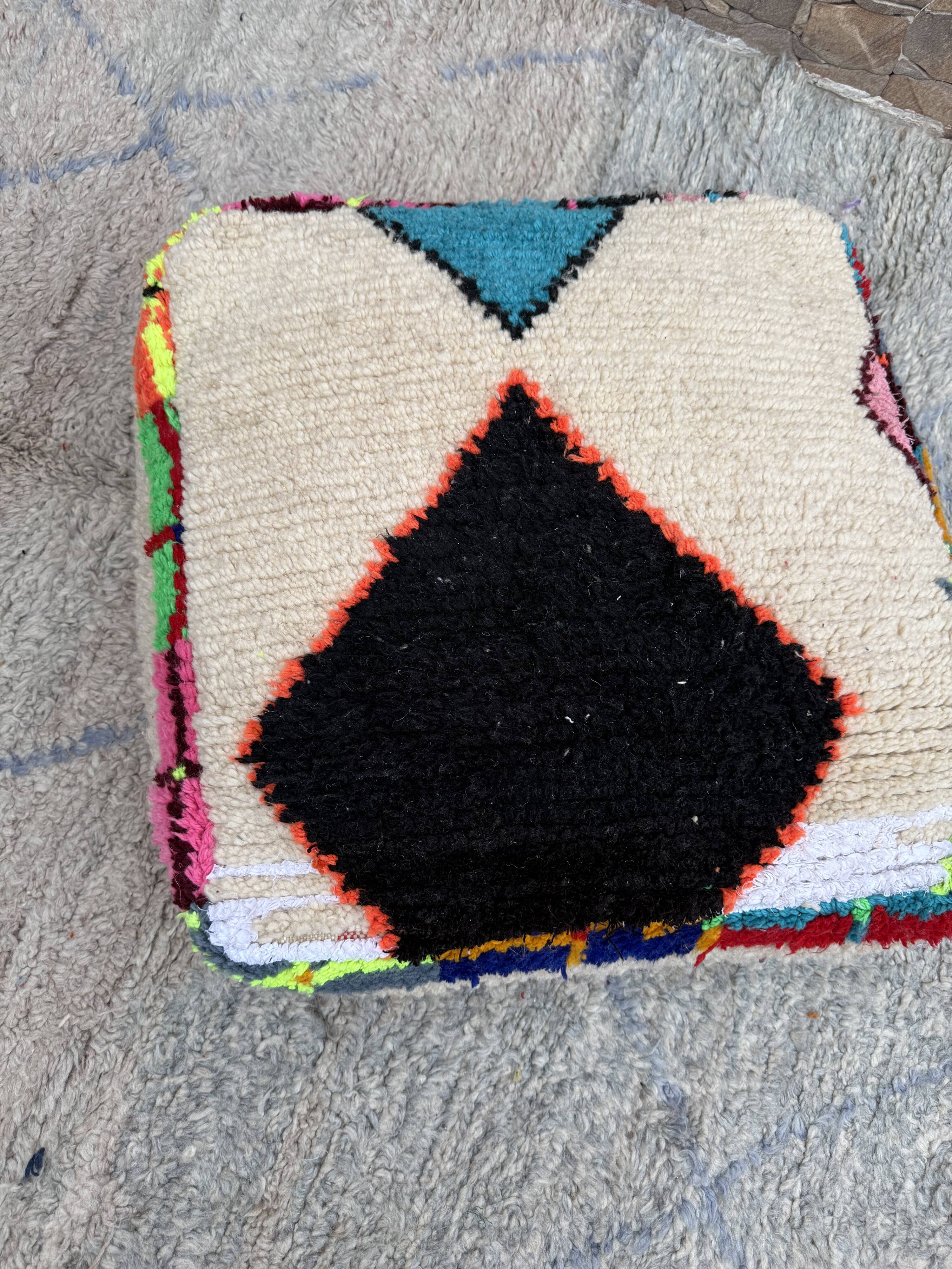 Berber floor pouf: Handwoven Moroccan wool cushion.