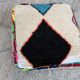 Berber floor pouf: Handwoven Moroccan wool cushion.