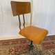 Old high workshop chair made of wood and metal.