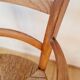 Antique campaign chair in wood and straw