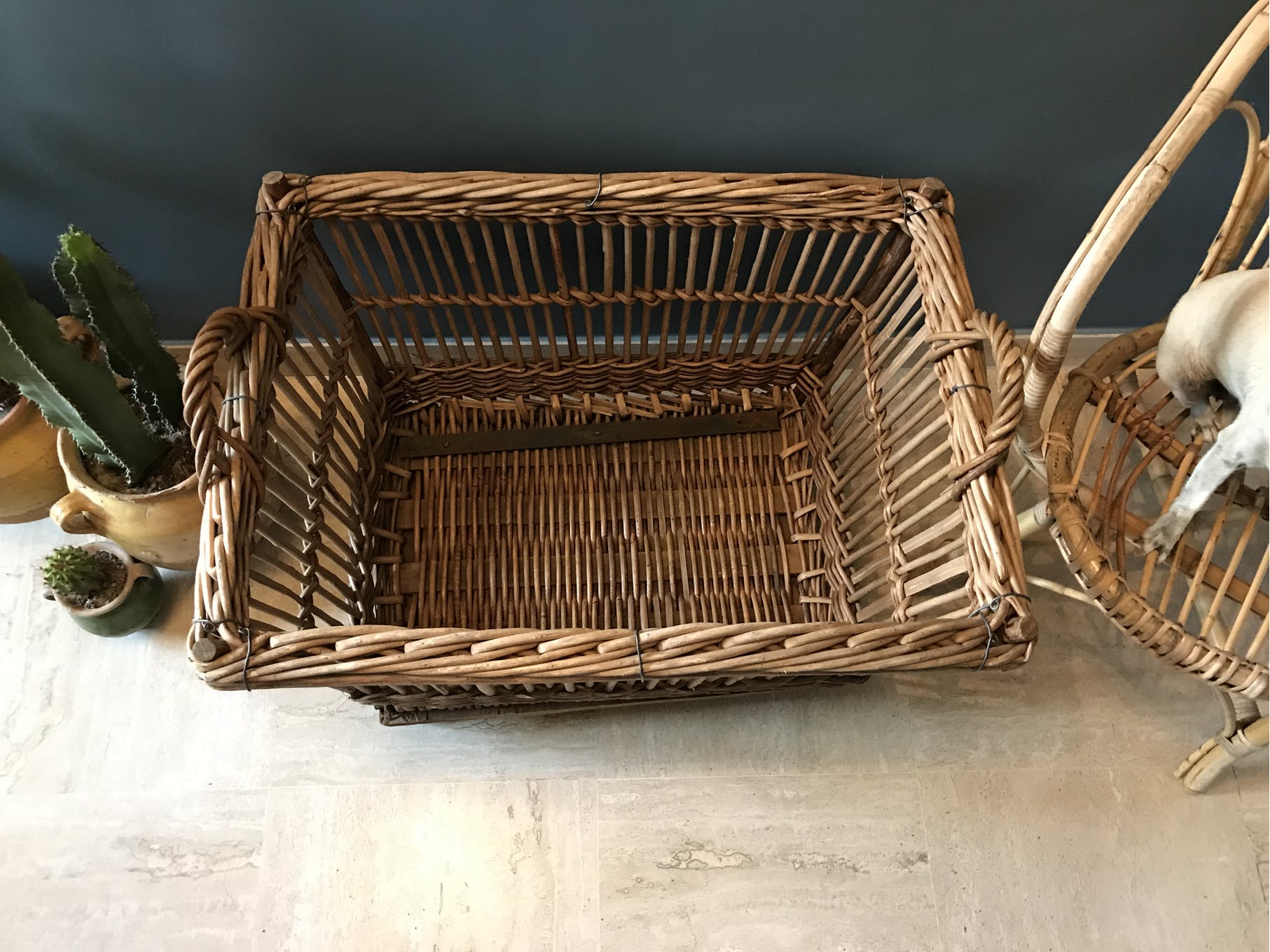 Rattan laundry basket on vintage wheels
