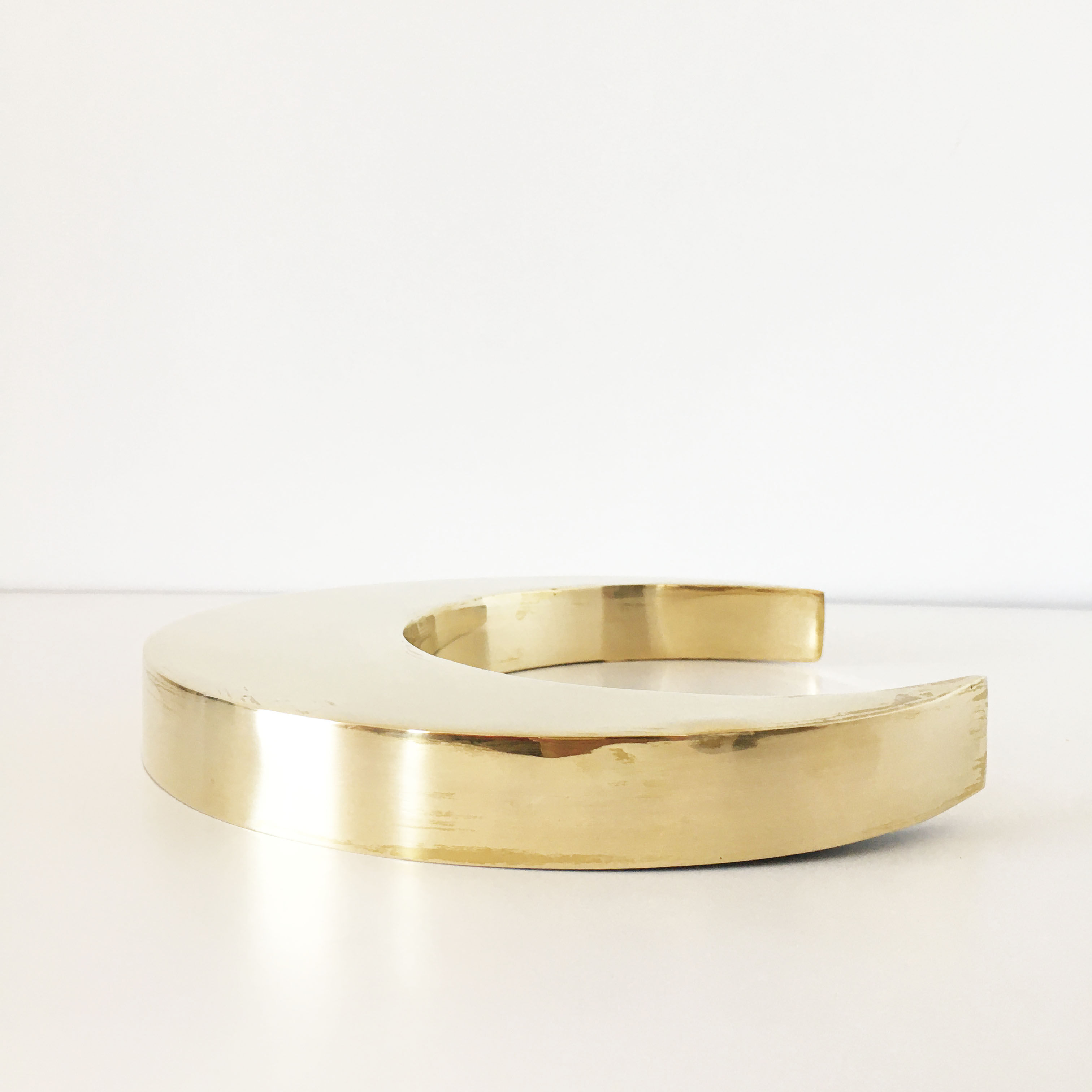 Moon or letter of sign "C" in vintage brass