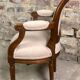 Louis XVI style children's armchair in carved walnut and beige antique upholstery