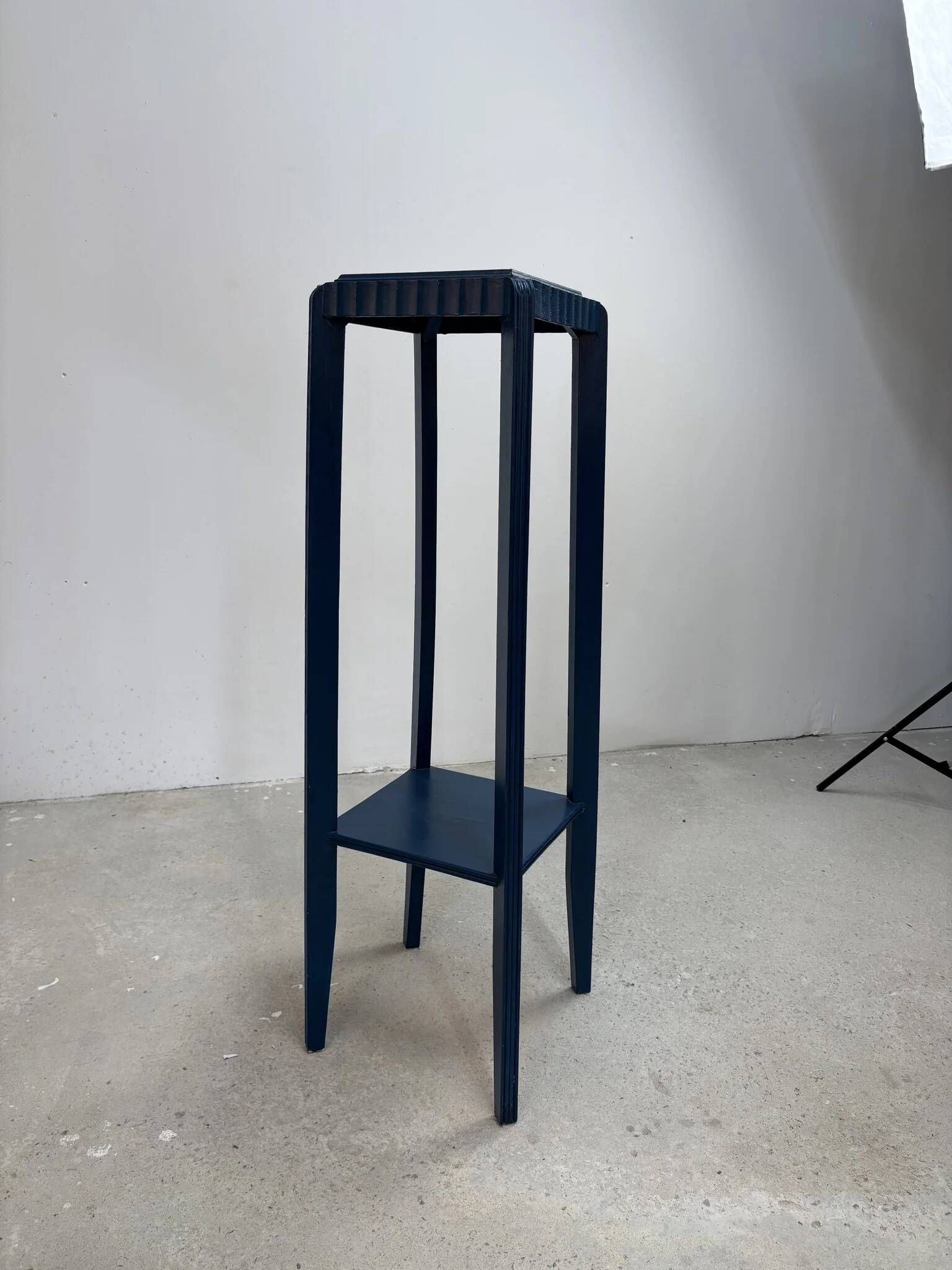 Blue side table with a veined stone top and a low shelf in the Art Deco style.