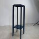 Blue side table with a veined stone top and a low shelf in the Art Deco style.
