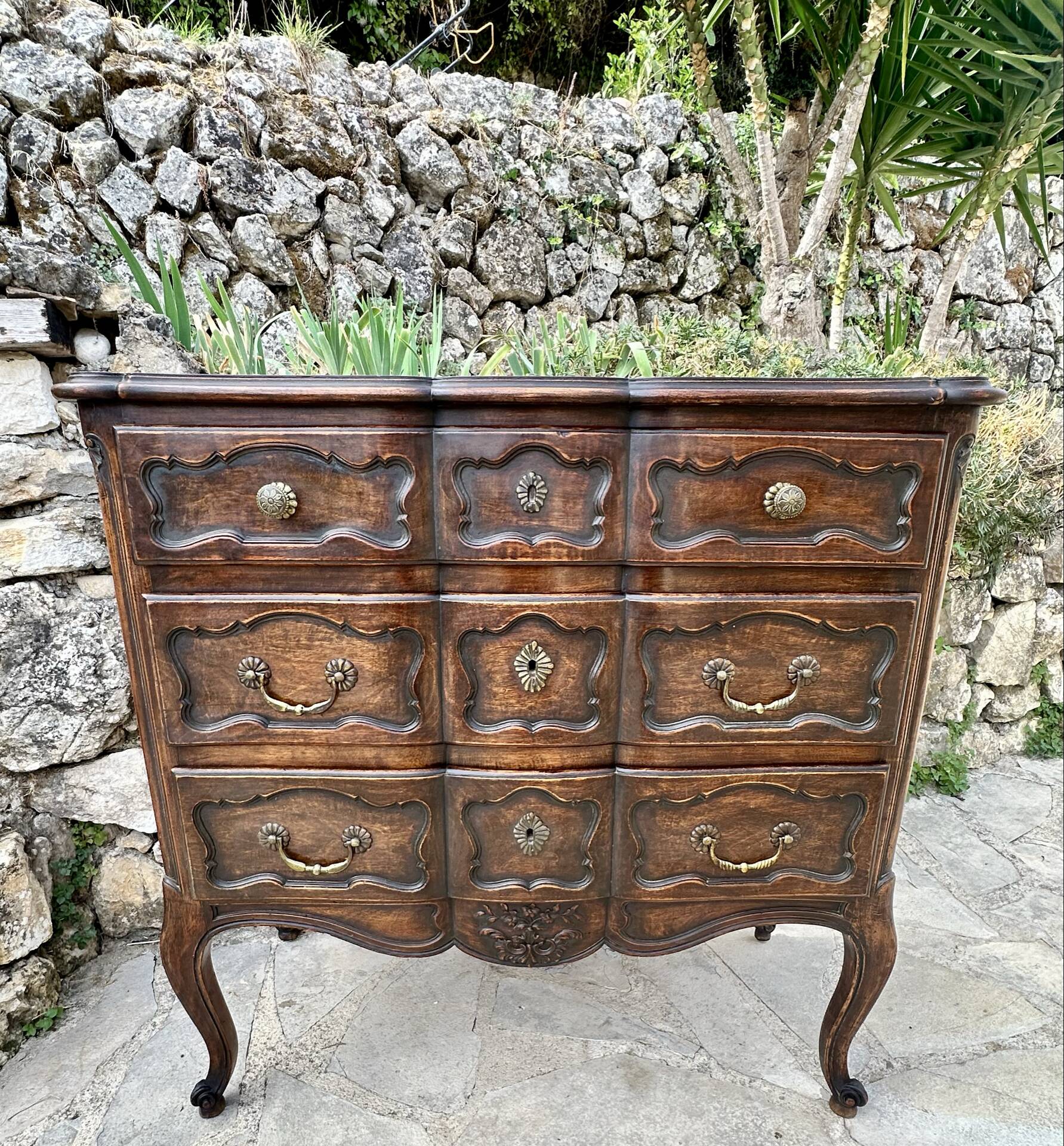 Carved and moulded solid wood commode in the Louis XV style.