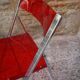 Red Plexiglas folding chair