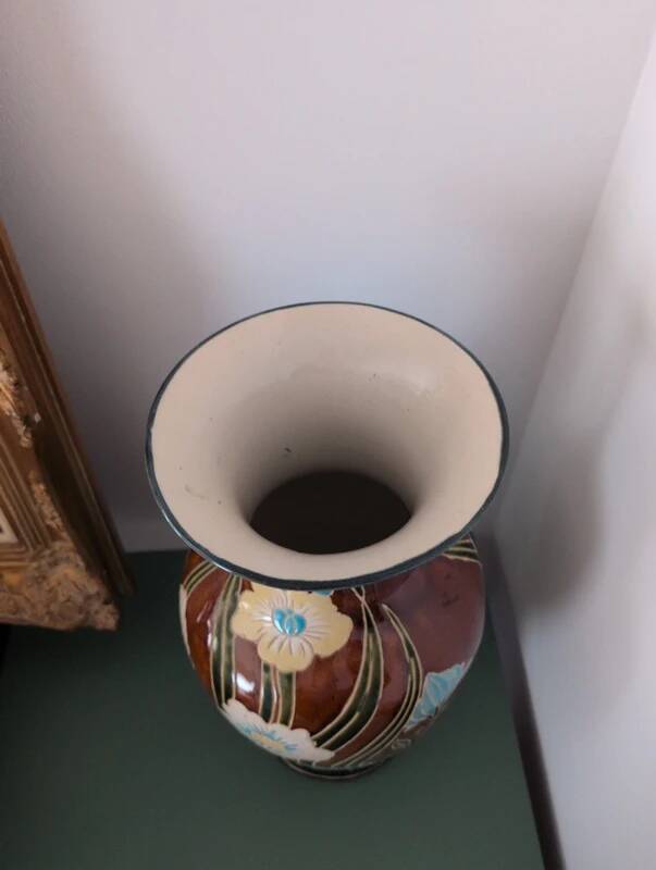 Large vintage antique vase with raised floral pattern.