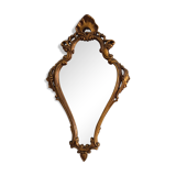 Old wooden mirror and gilded stucco