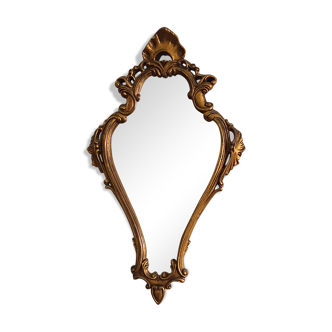 Old wooden mirror and gilded stucco