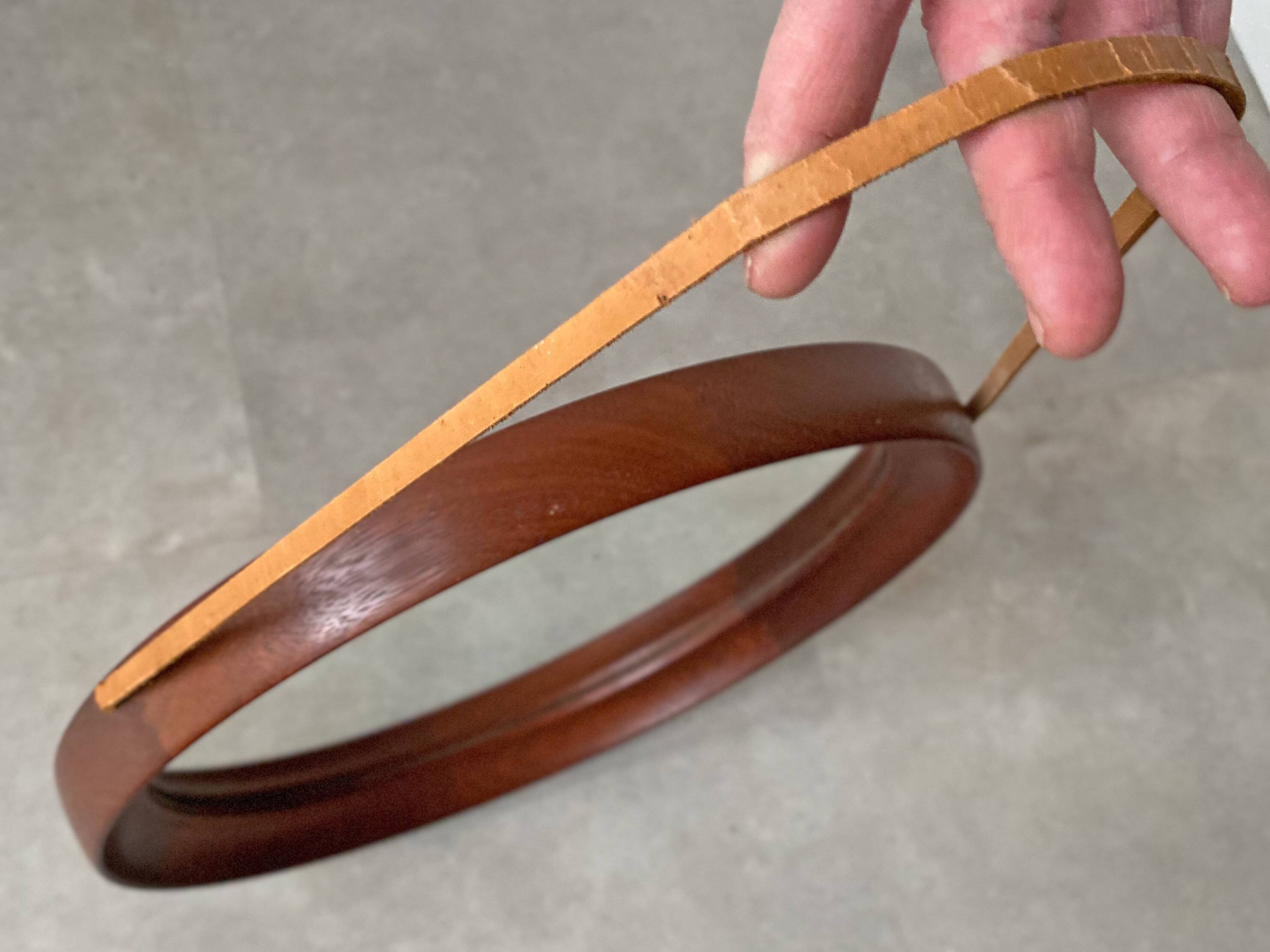 Mid Century solid teak wall mirror with a leather strap - Danish design