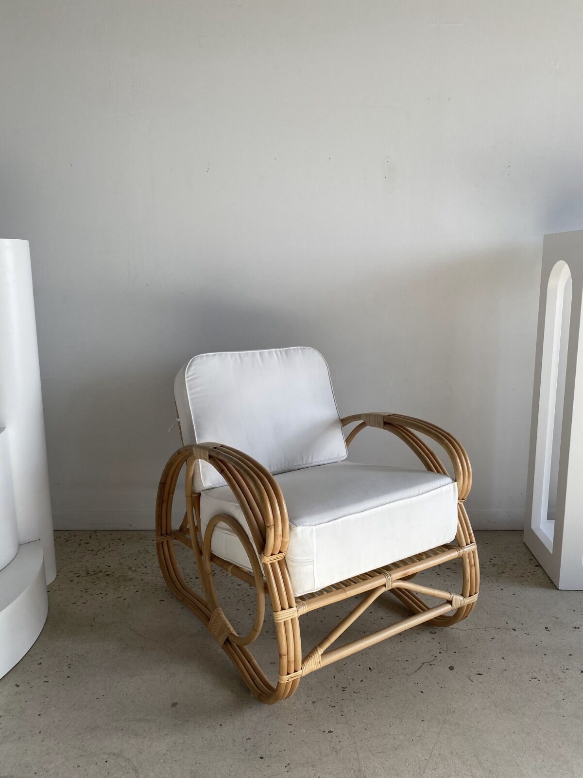 Large rattan rest chair and white cushions