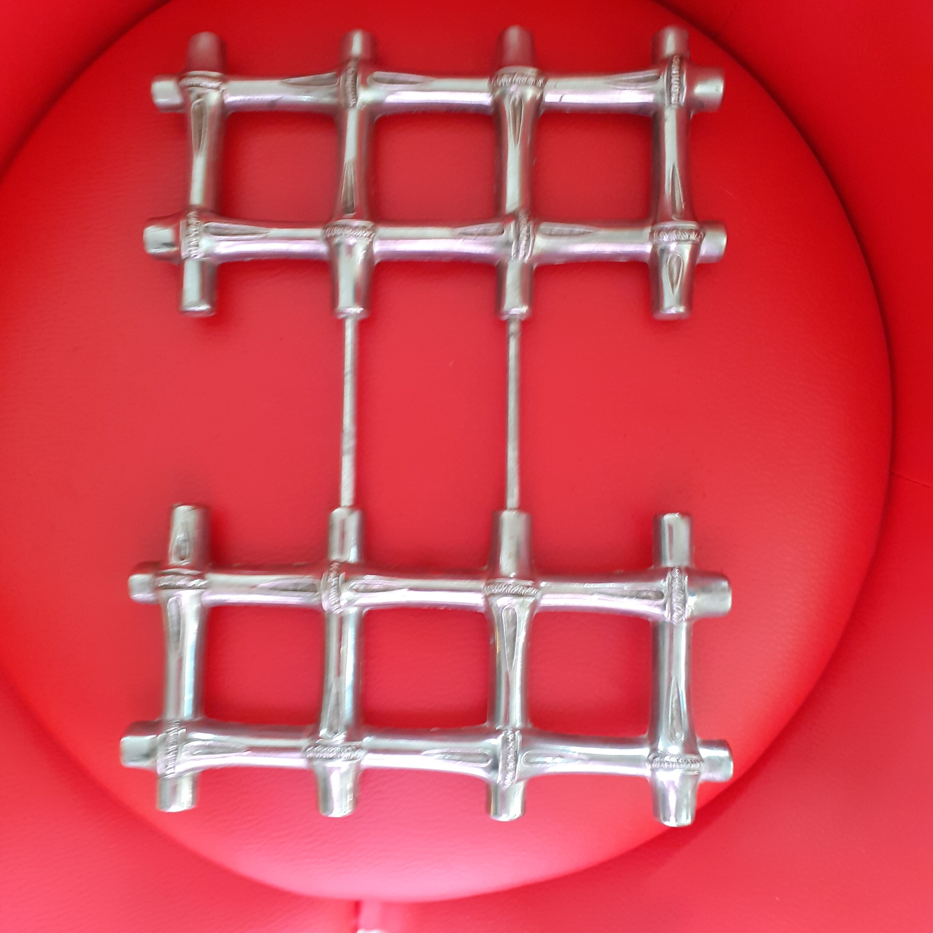 Expandable silver metal trivet in rush style