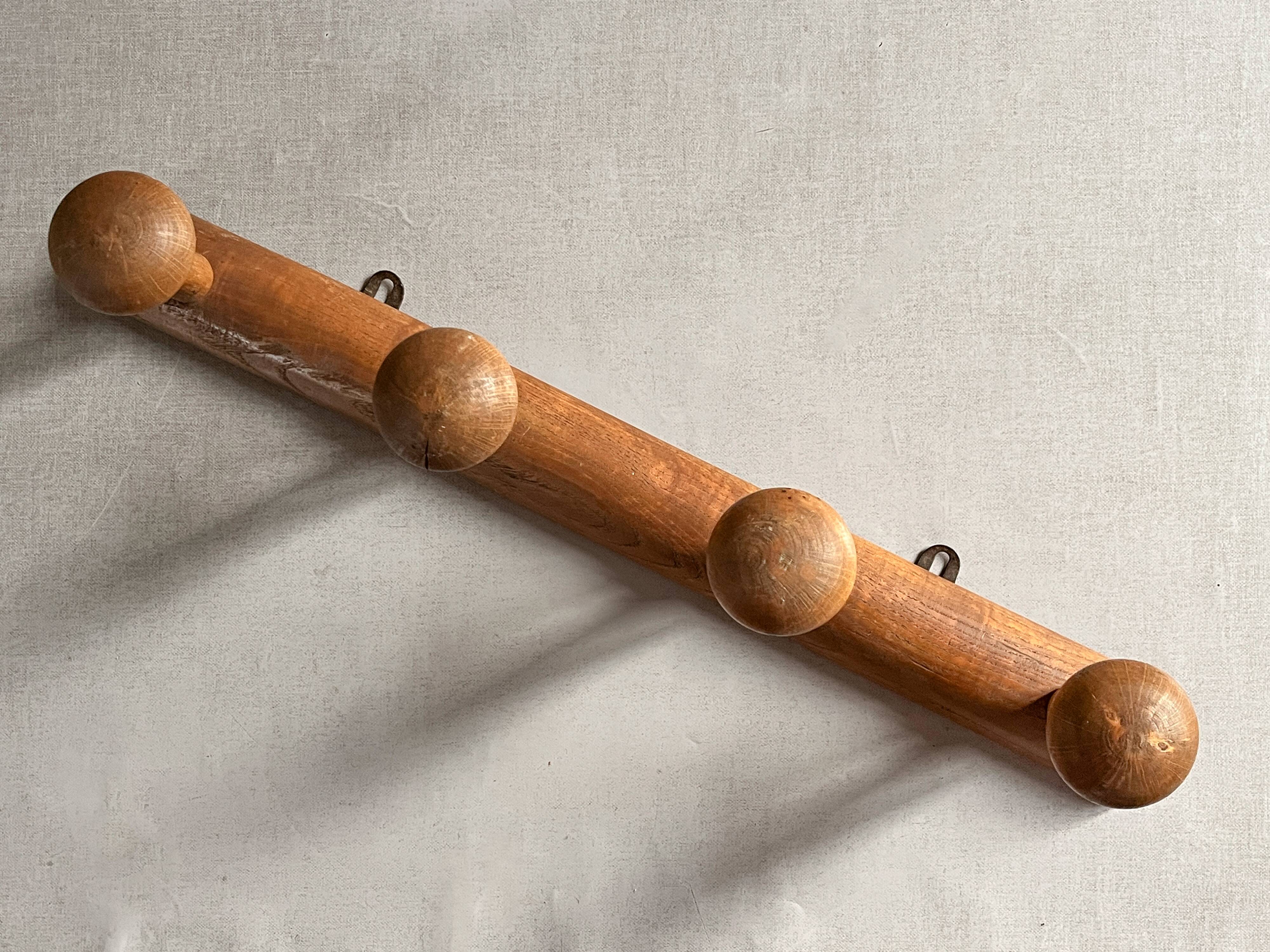 Varnished wooden wall coat rack with 4 hooks, antique item.