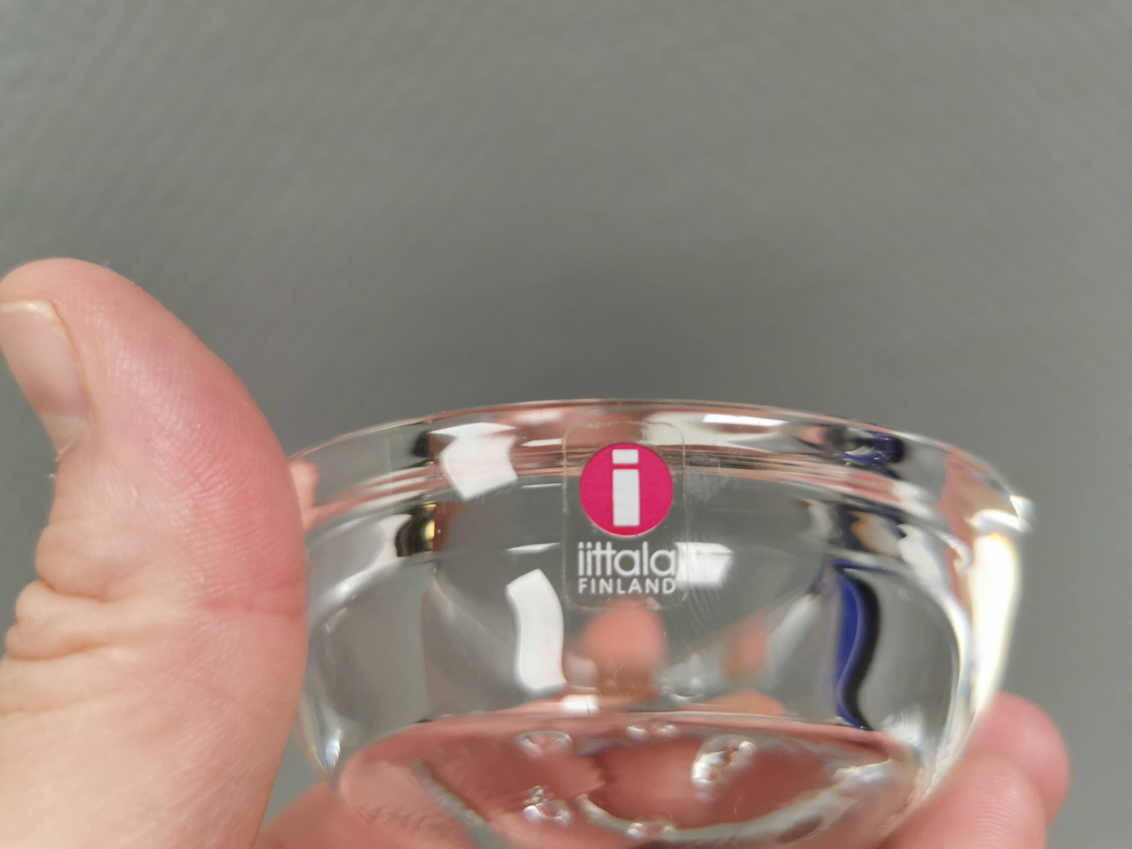 A set of iittala candle holders in clear transparent glass.