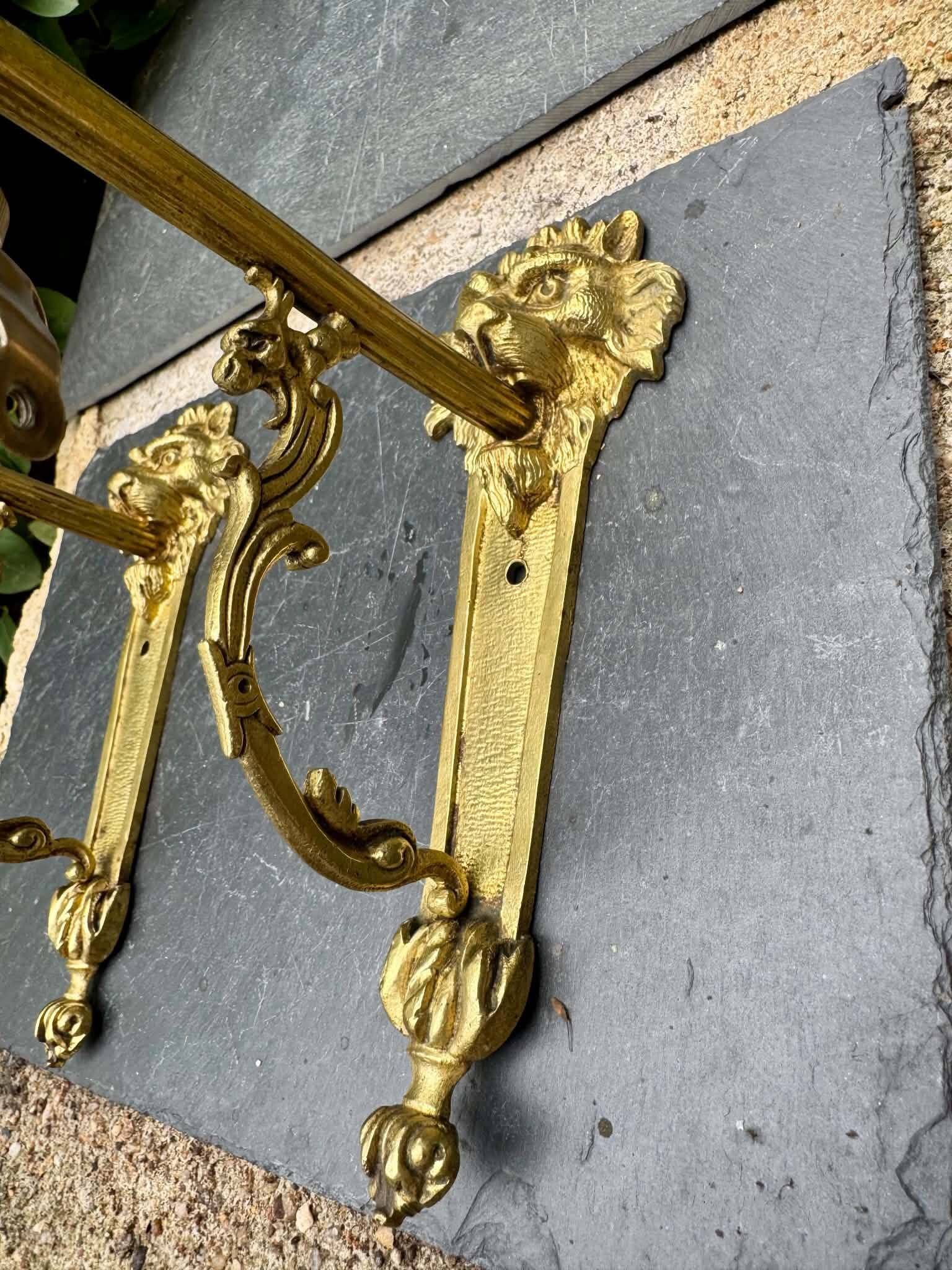 2 brass lion Empire wall sconces