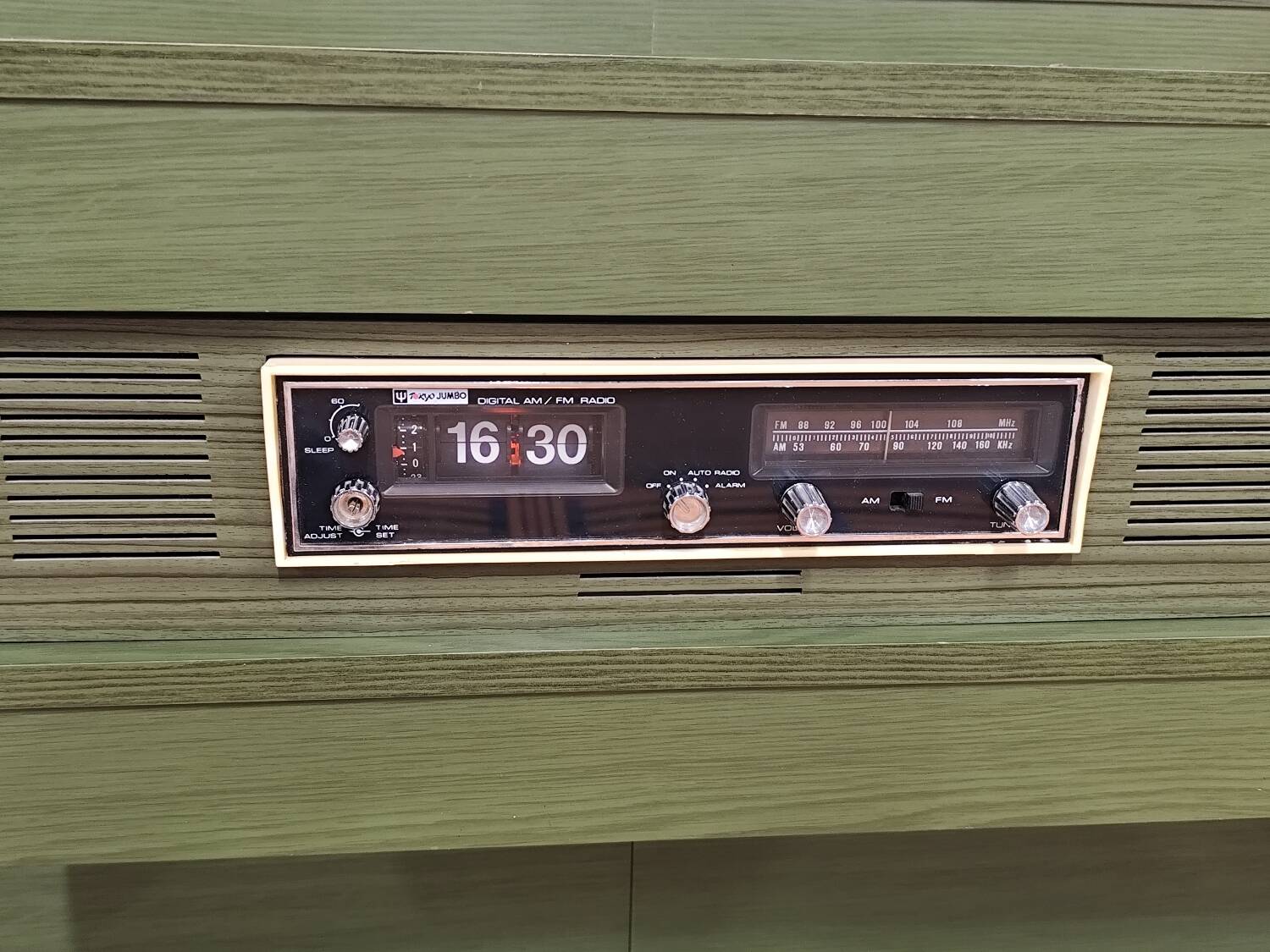 Vintage king-size bed with headboard furniture and built-in radio.