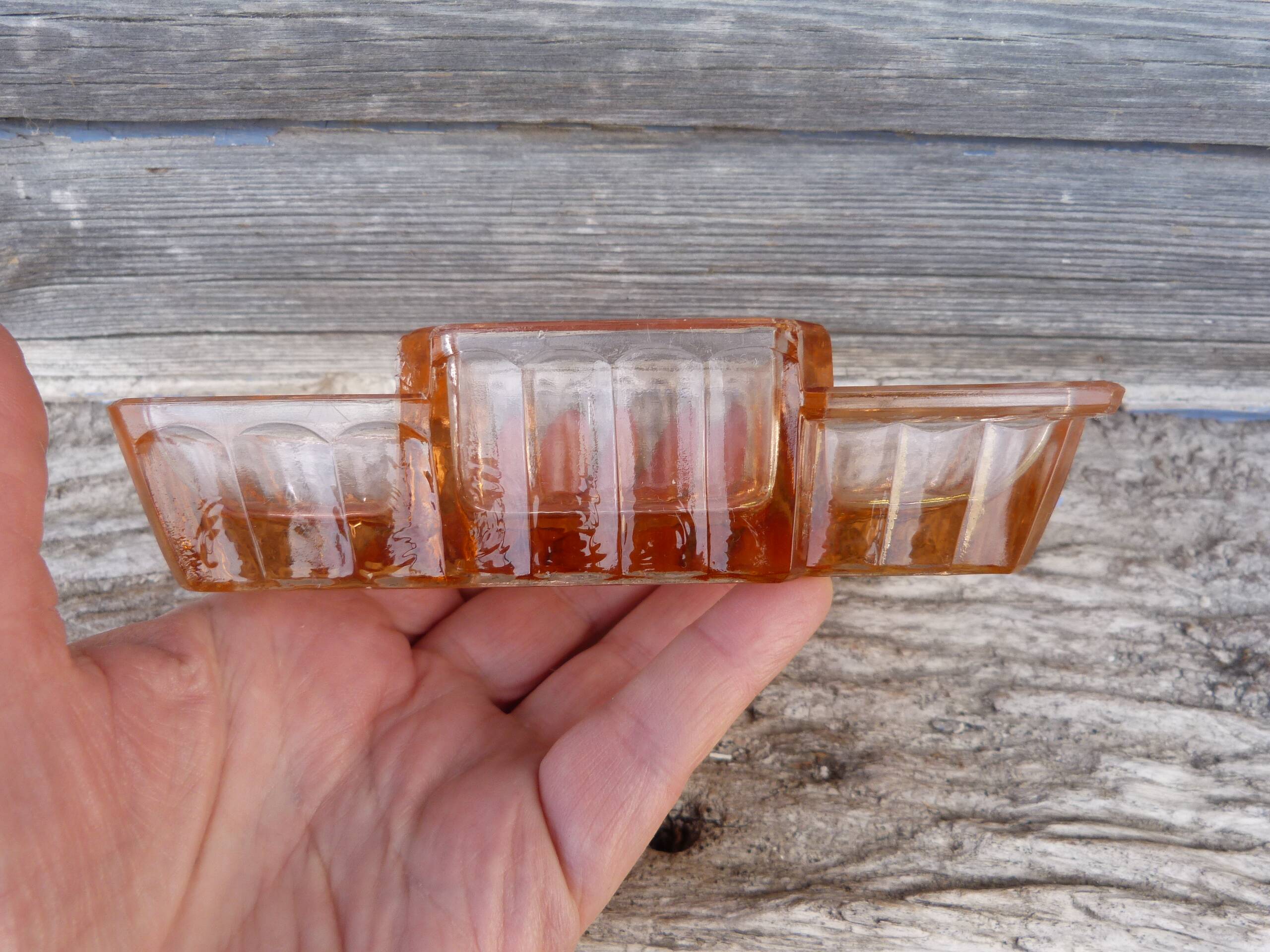 Glass condiment service in transparent pink moulded glass.