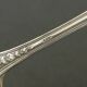 Set of 11 SFAM silver metal teaspoons.