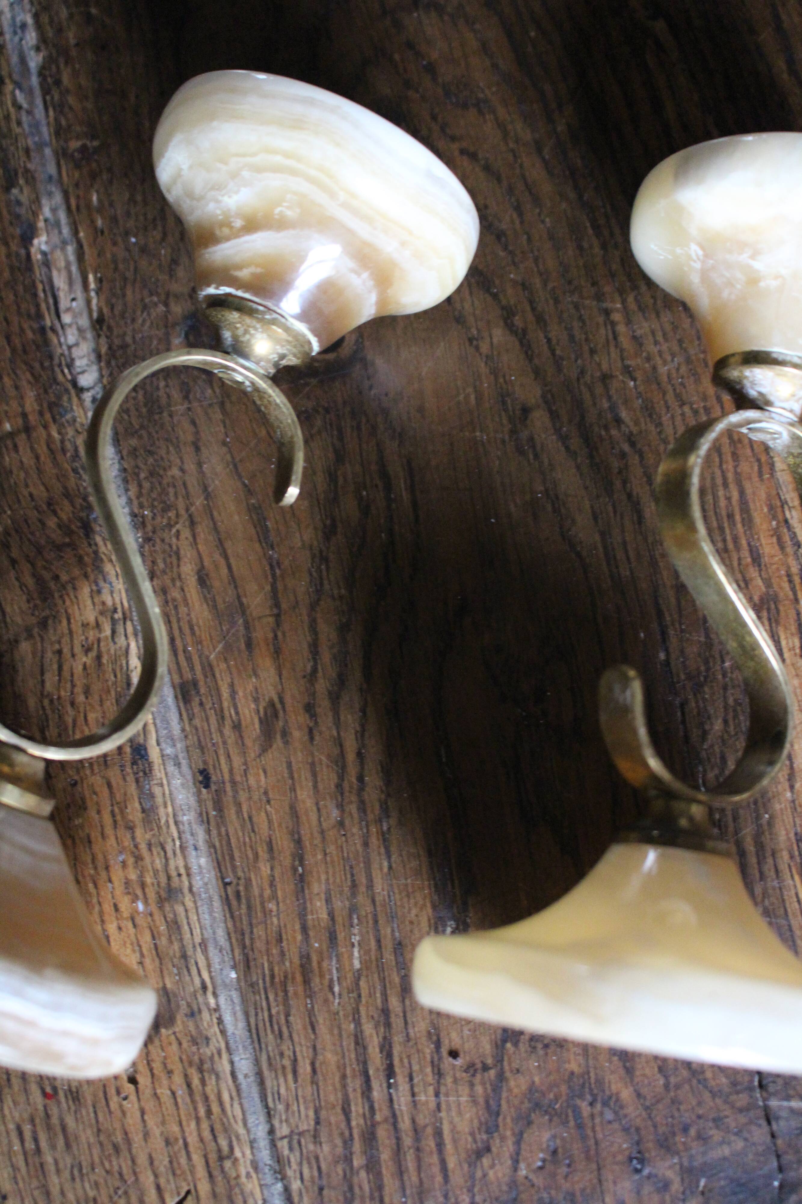 Pair of curved brass candlesticks with onyx