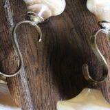 Pair of curved brass candlesticks with onyx