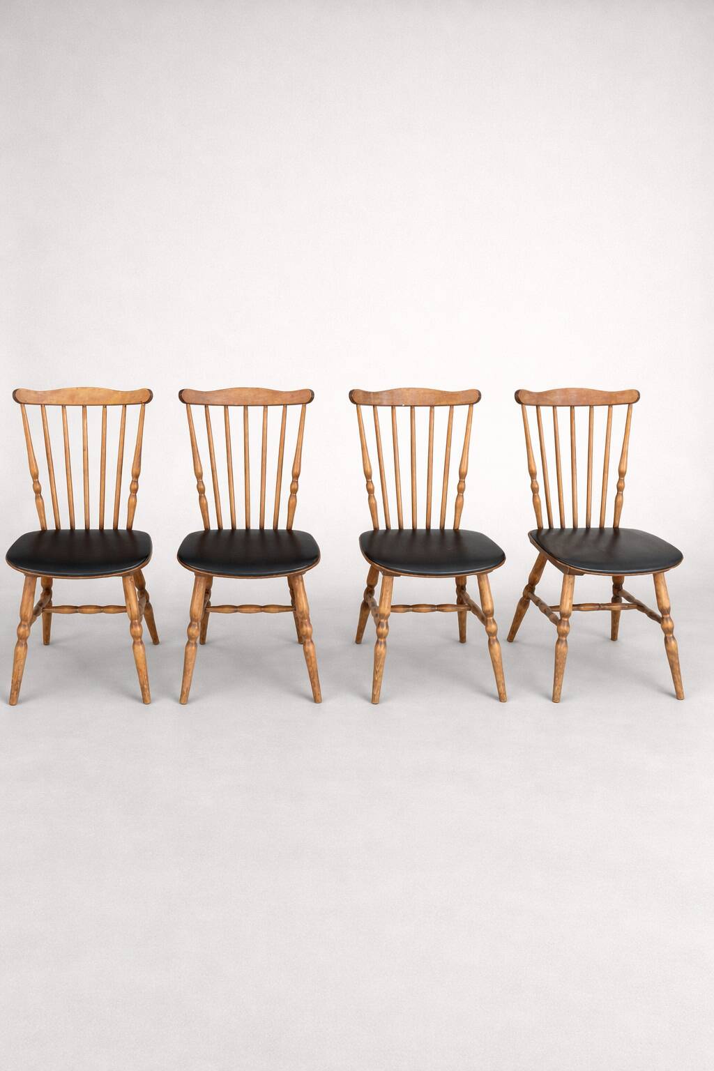 Set of 4 Baumann "Menuet" chairs – stained beech and black faux leather – French design