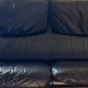 Black leather two-seater sofa