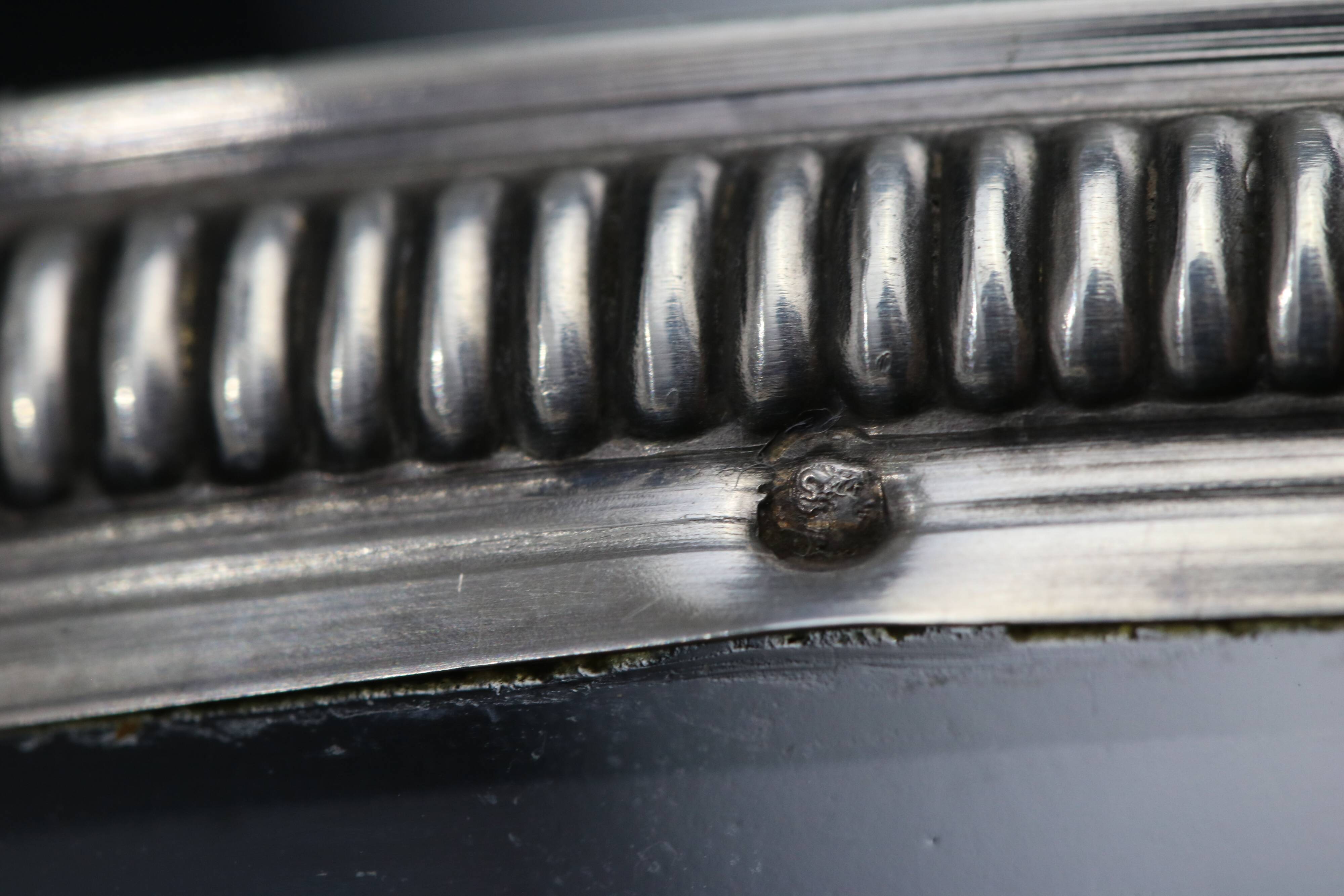Crystal cup surrounded by two silver friezes
