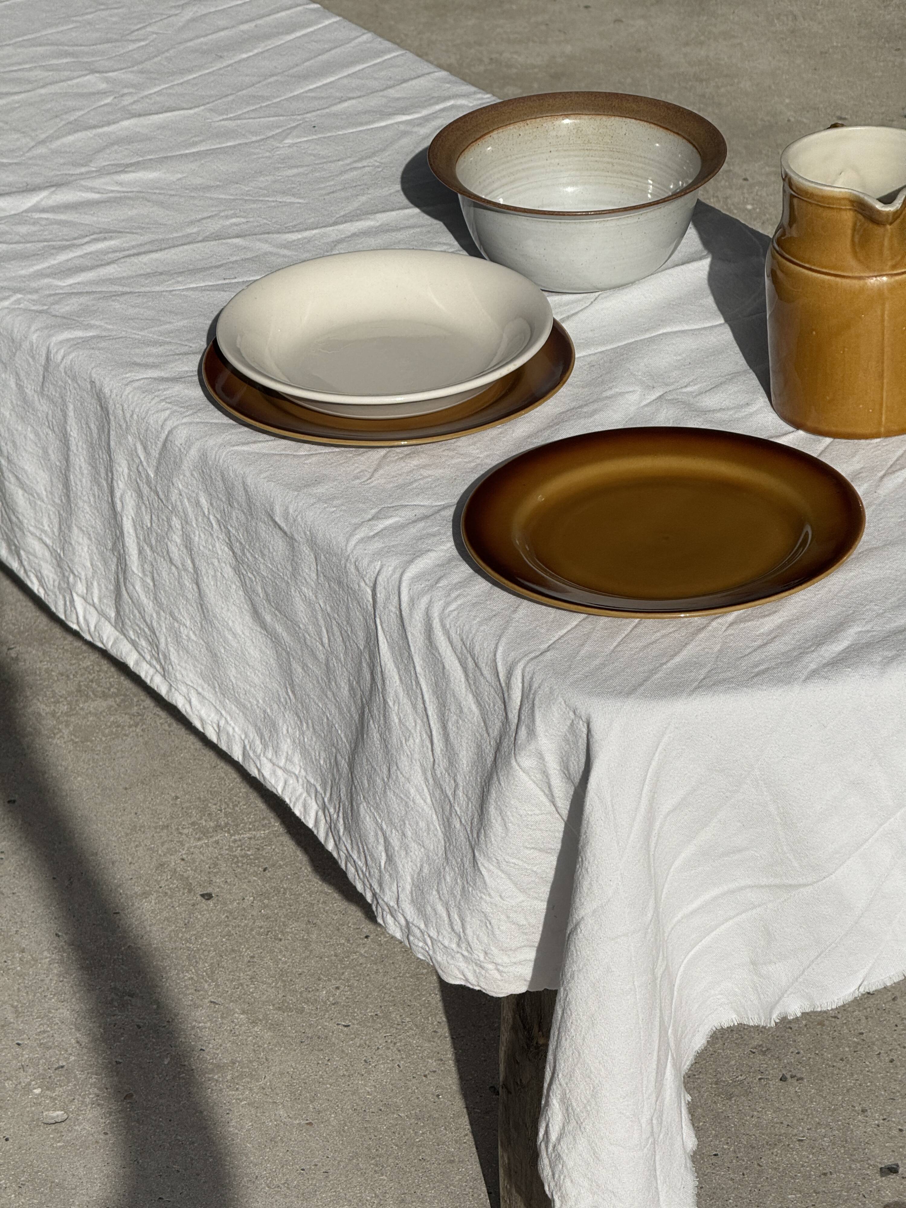 Small thick stoneware bowl with a stylised flower pattern in white on the outside, b