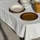 Small thick stoneware bowl with a stylised flower pattern in white on the outside, b